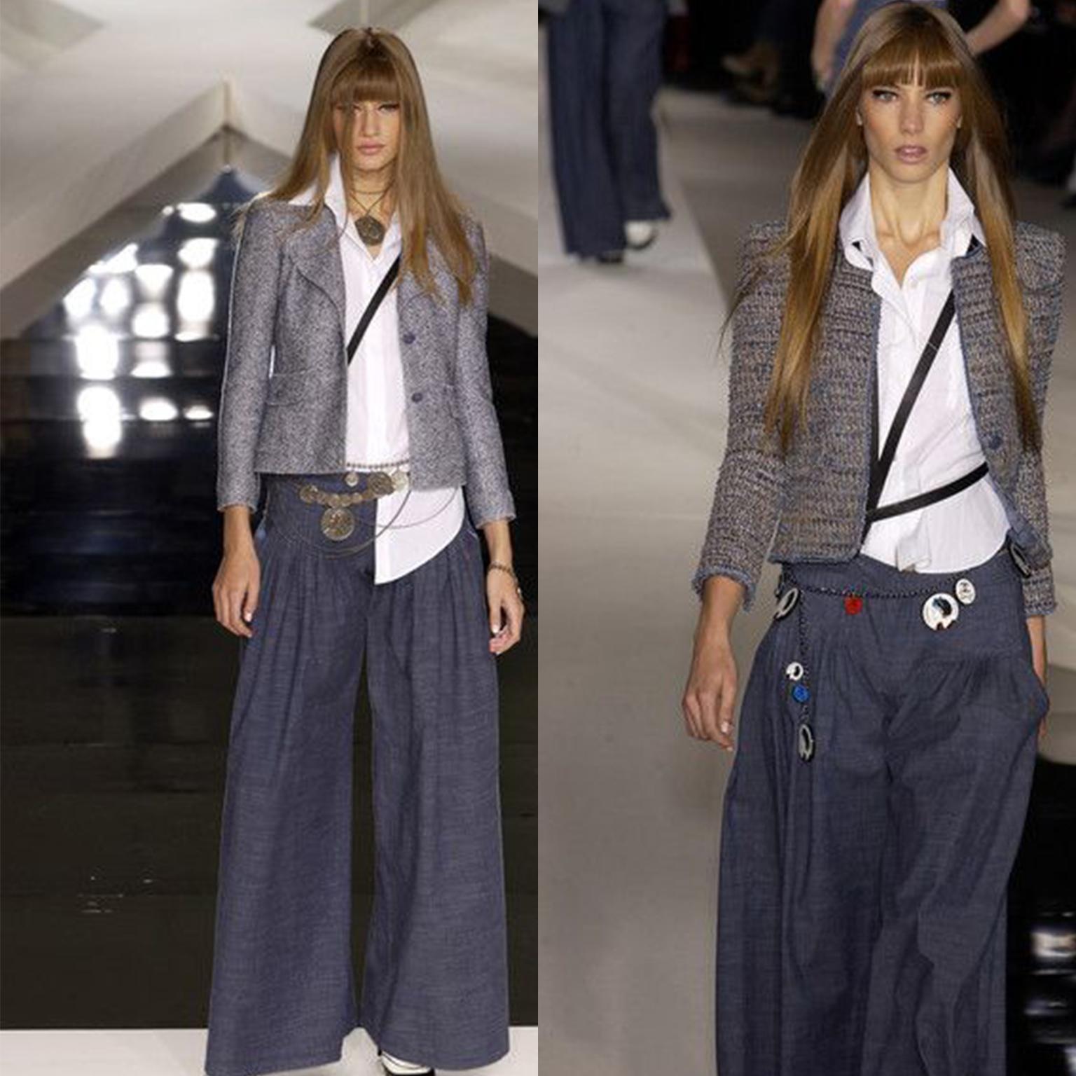 This is a documented pair of pleated grey/blue lightweight denim trousers from the Spring 2003 Chanel runway collection. These are quintessential early 2000's vintage pants and we love the super wide legs! The color is a medium wash with a greyish
