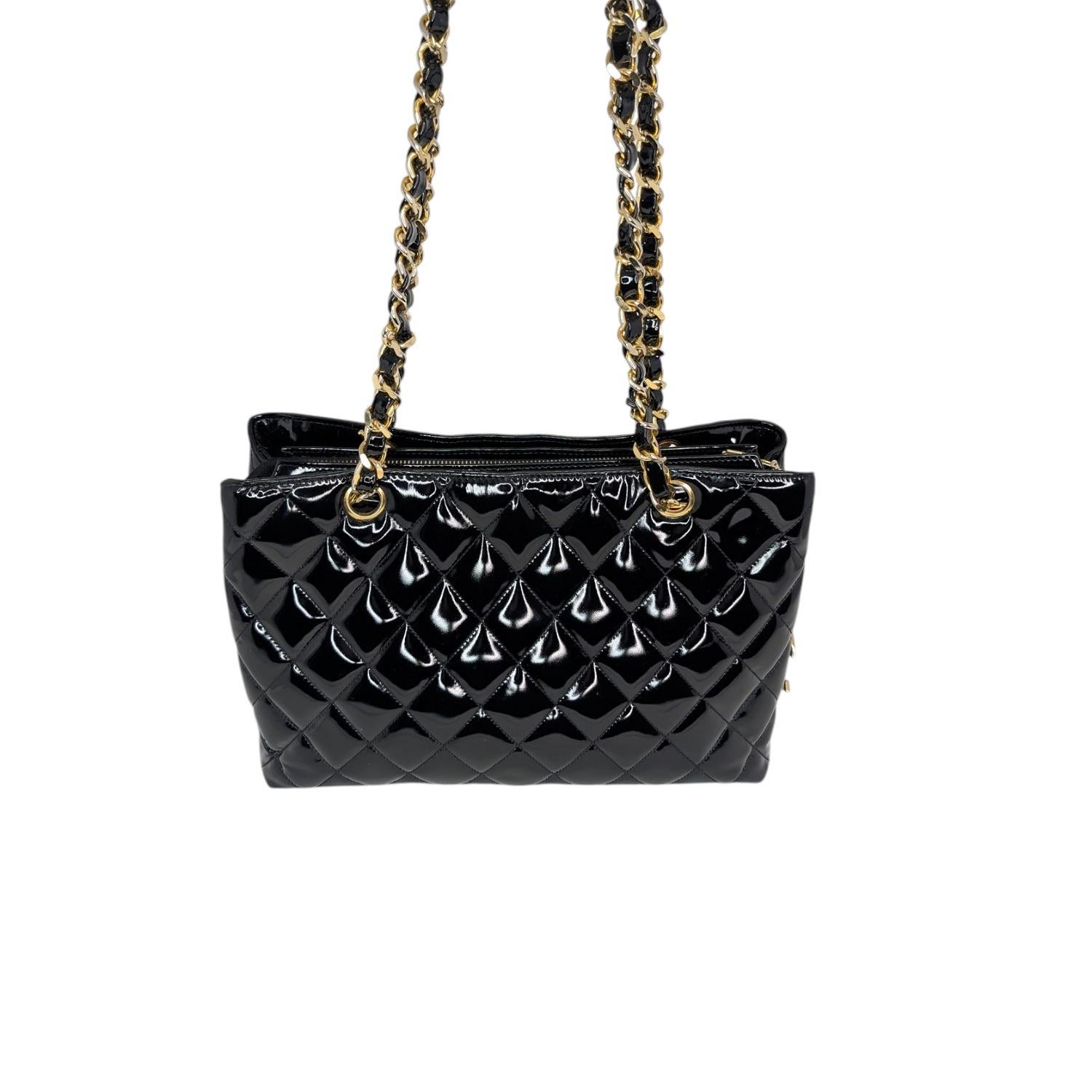Elevate your collection with this stunning and rare Chanel Vintage Patent Quilted CC Chain Tote. Crafted in Italy between 1989 and 1991, this glossy black patent calfskin tote is a true piece of fashion history. The iconic quilted exterior is
