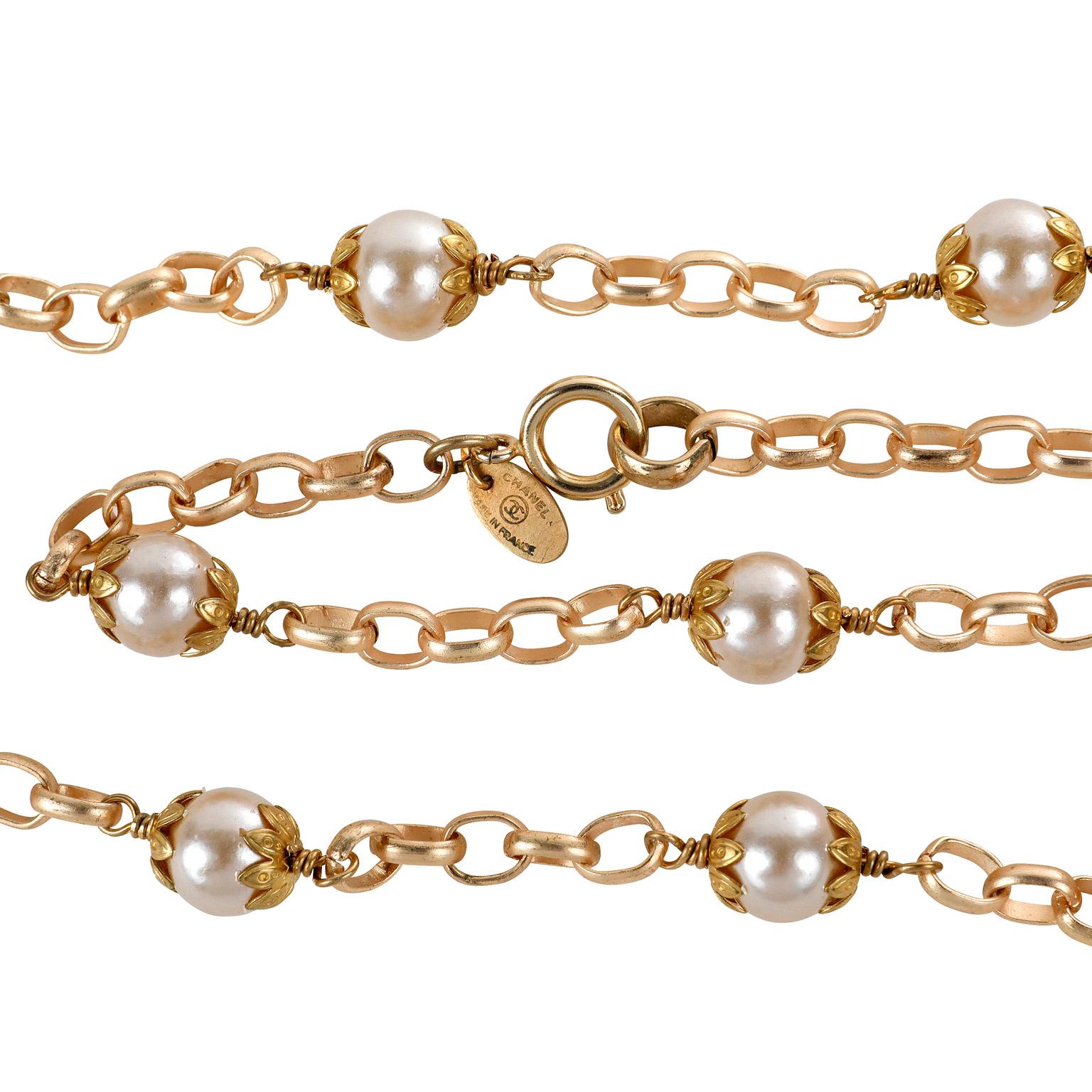 This authentic Chanel Pearl and Gold Link Necklace is in excellent vintage condition from the 1980’s.  Single faux pearls are situated on a long matte gold linked chain.  22 inches long with adjustable length.   Made in France.  Pouch or box