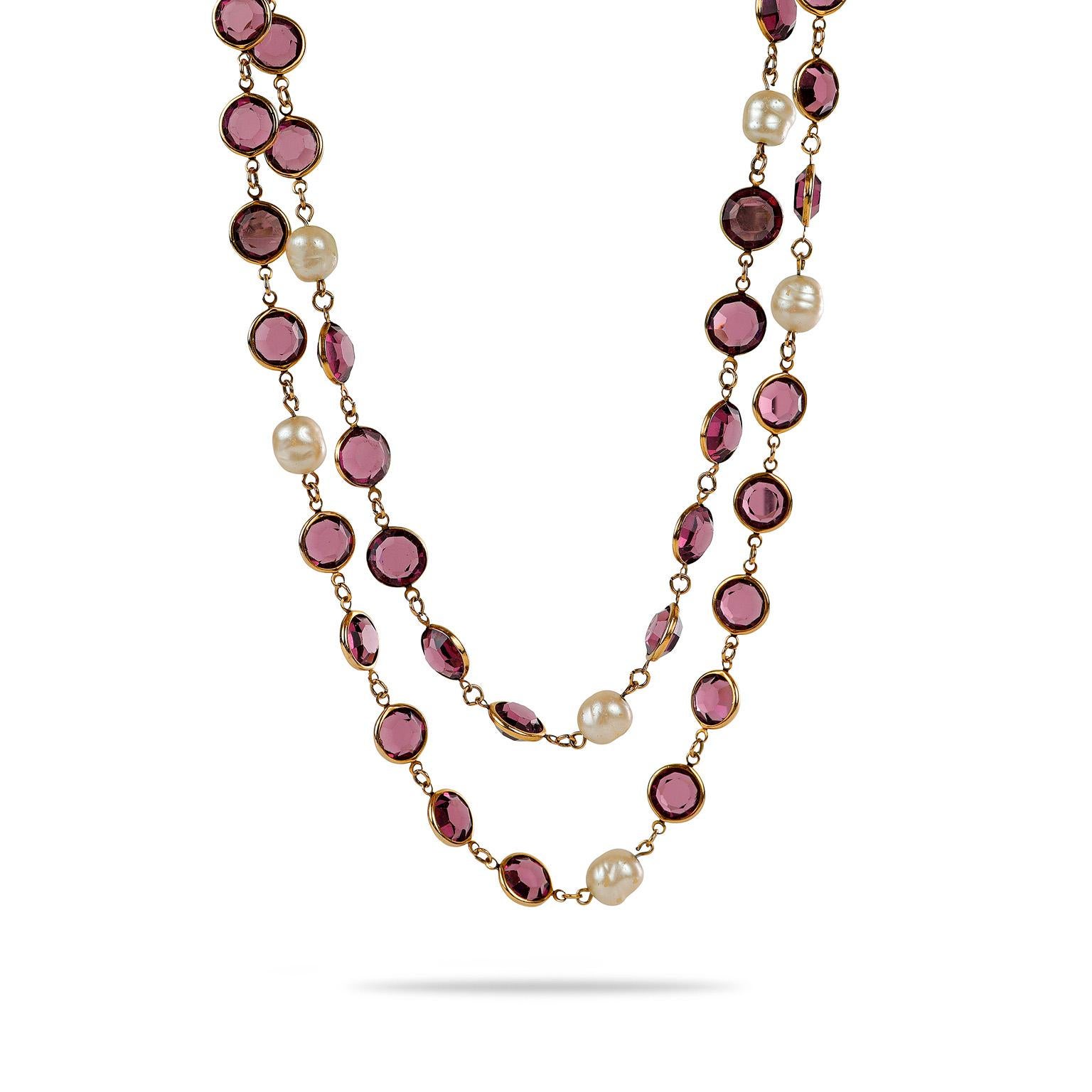 Cet authentique collier Satoir de Chanel en perles et cristal violet est en excellent état vintage de la collection 1981.  Des cristaux violets taillés en rose et des fausses perles sont situés sur une chaîne extra longue de couleur or.  Pochette ou