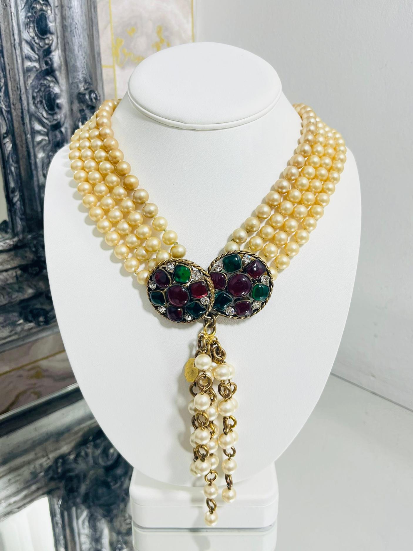Chanel Vintage Pearl & Gripoix Necklace By Victoire de Castellane

Pearl necklace which featuring ornate gripoix and crystal detailing.

Four strands of faux pearls with 24k gold plated trim, set with multicoloured 

glass/gripoix, crystals and