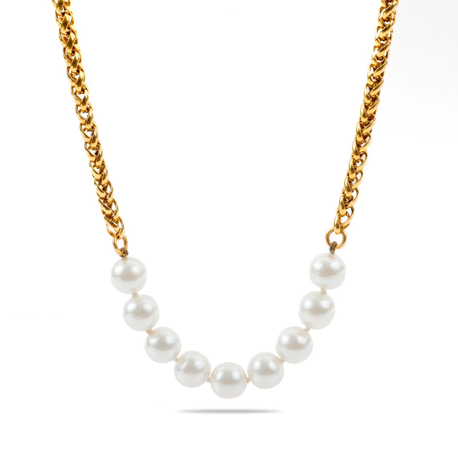 This authentic Chanel Pearl Station Necklace is in excellent vintage condition from the early 1980’s.  Three sections of faux white pearls are stationed along a gold tone wheat style chain.  Made in France.  Pouch or box included.

SKU 831/ 11204