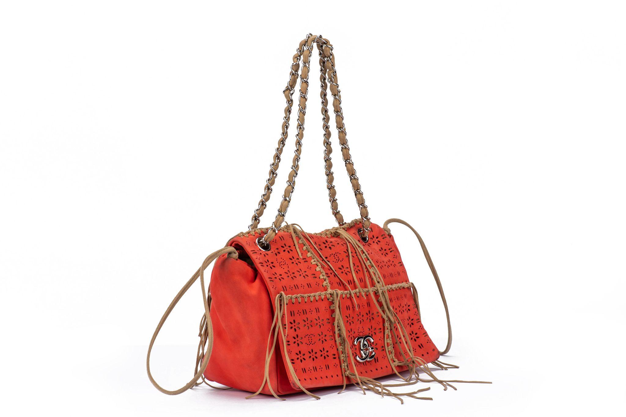 Chanel Vintage CC Turnlock Flap Tote featuring Perforated Leather in orange. The bag has several tangles on both ends of it. The interior is made of canvas in a light brown. Collection #14, 2010/2011. Handle drop 8.5”. The item is in excellent