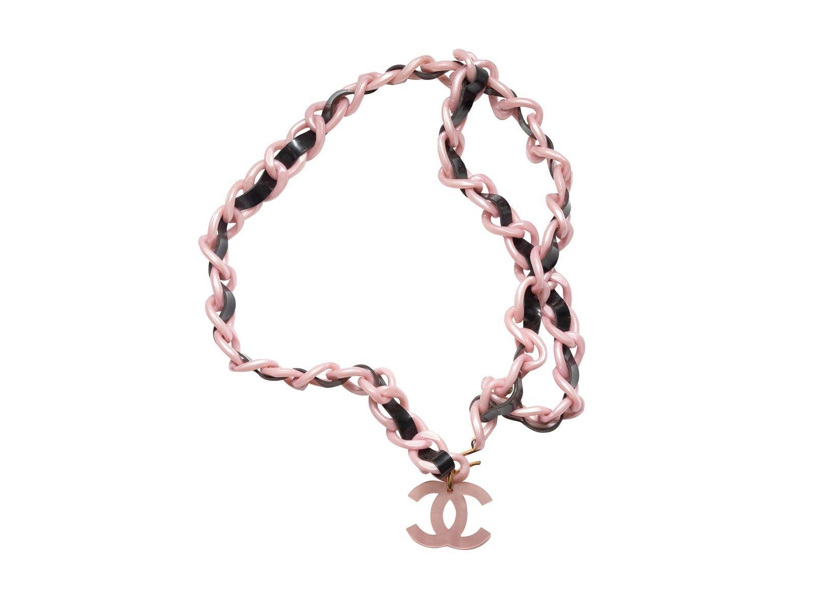 Product Details: Vintage pink and black acrylic chain belt by Chanel. Circa 1994. CC logo charm at end. 0.5