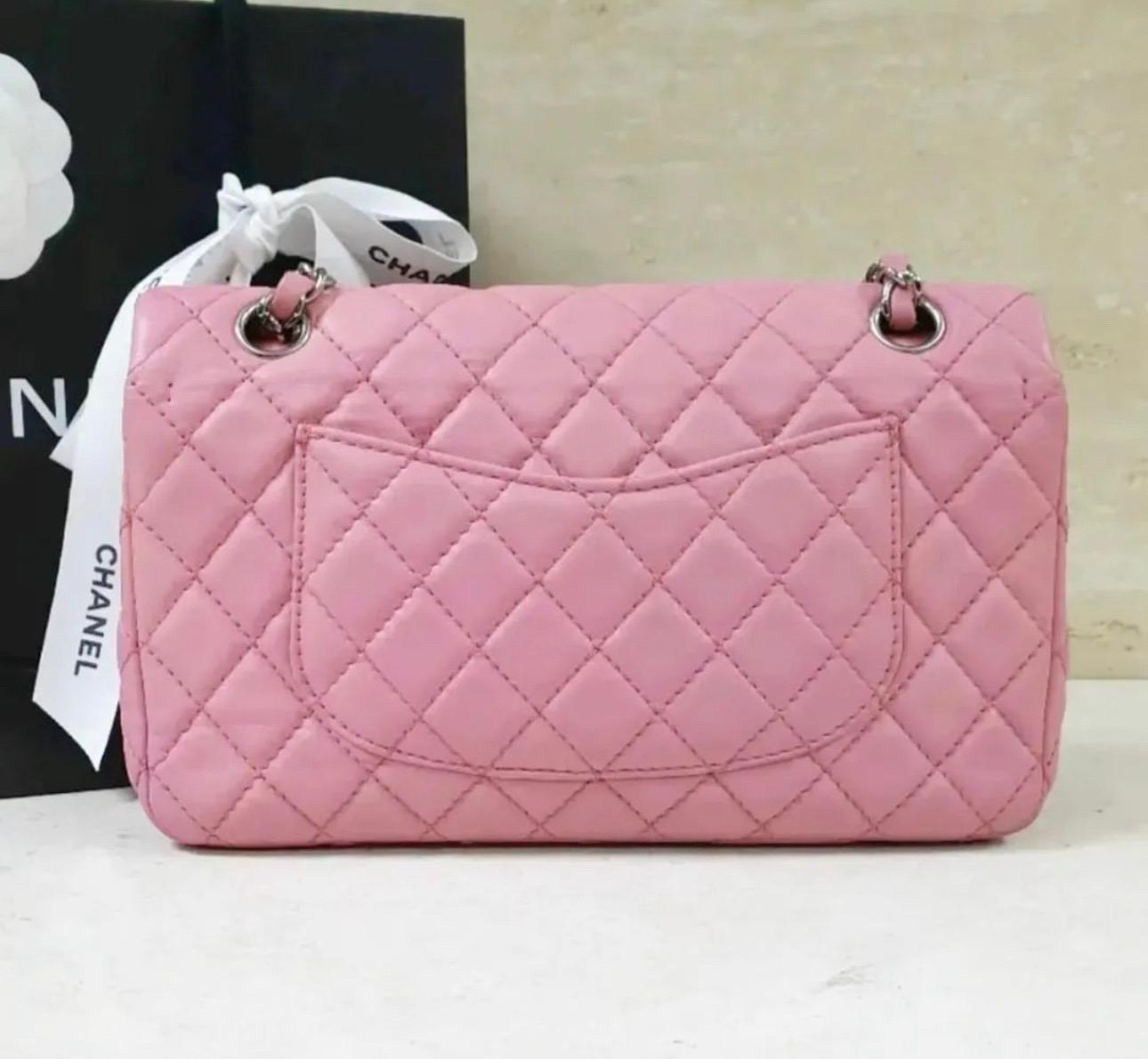 The timeless double flap bag in pink leather features silver CC turnlock and chain, which can be worn long or doubled to go over the shoulder. 
This medium size is perfect for day or evening. Hidden pockets on either sides of the bag. The inside