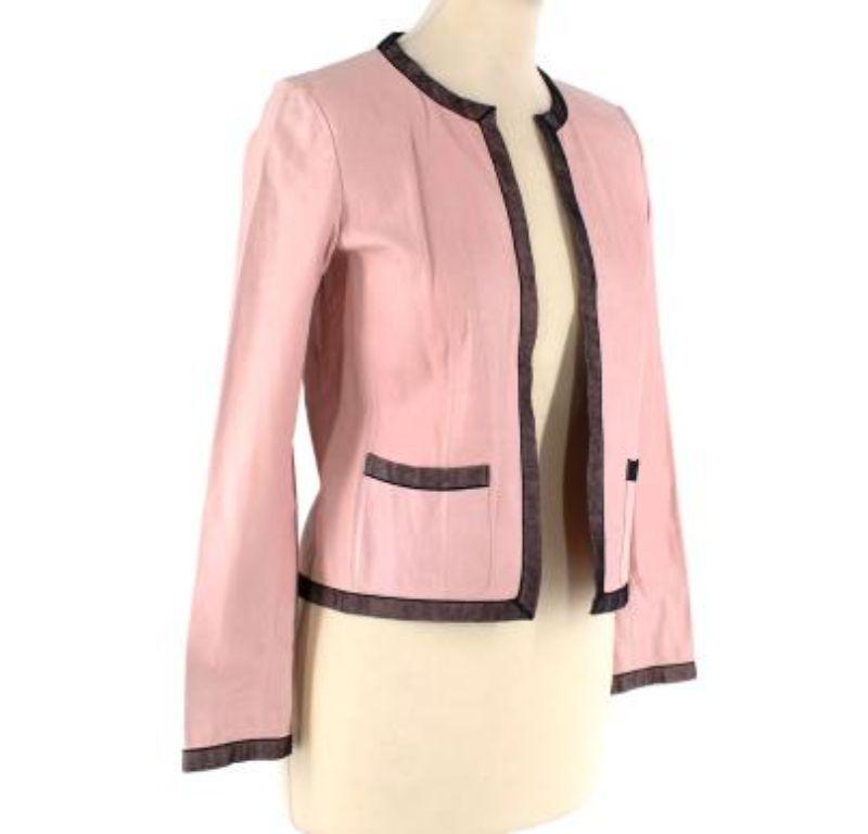 Chanel Vintage pink leather jacket

- Made of luxurious lambskin. 
- classic fitting jacket. 
- 2 exterior pockets.
- Black trim around the jacket.
- Long sleeves.
- unlined

Made in France.
Cleaned by a professional leather cleaner only. 
Condition