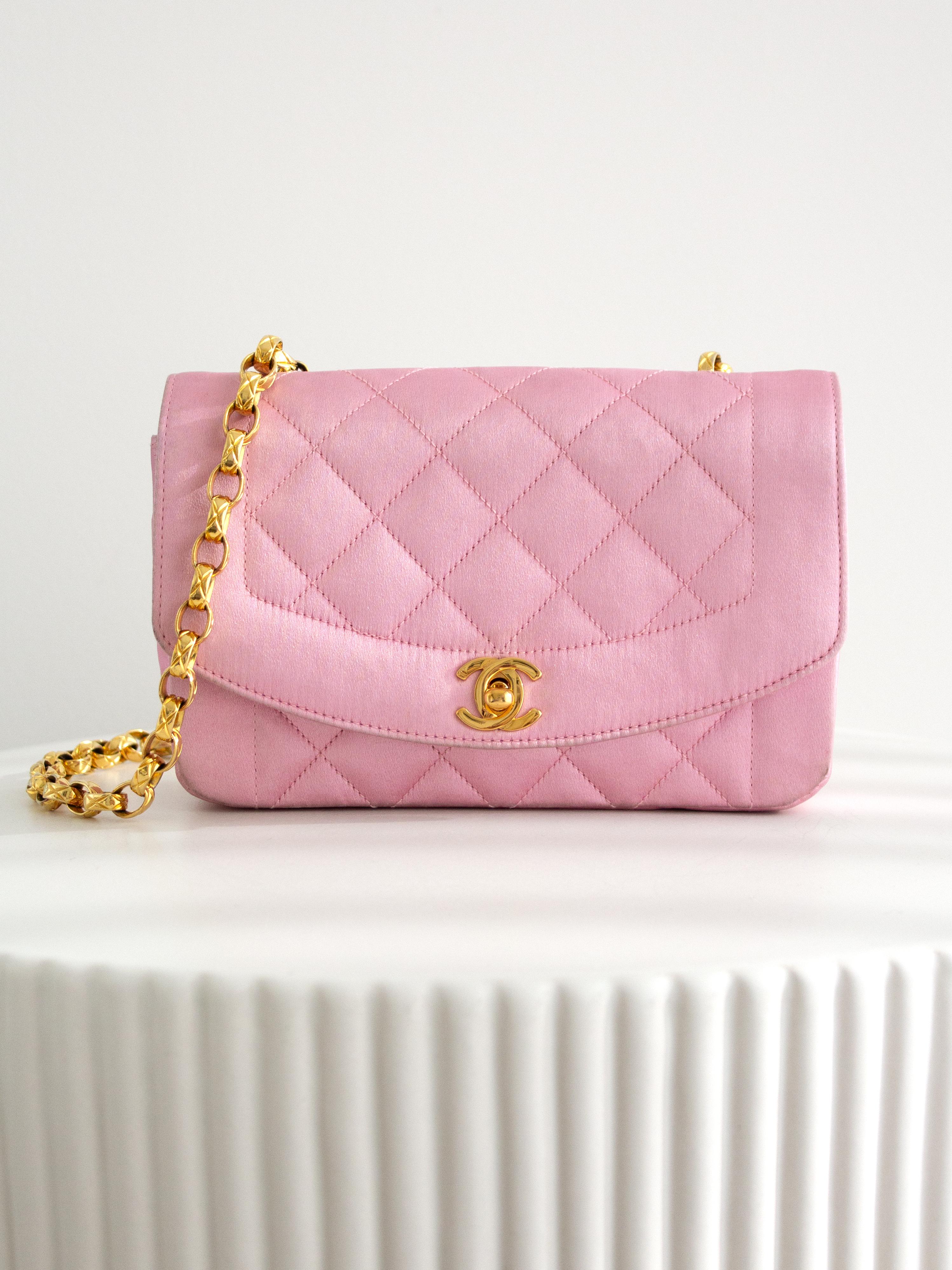 This super rare and adorable mini Chanel Diana bag is a vintage treasure from the early '90s, part of the 1-series collection from 1989 to 1991. It is crafted from luxurious pink silk, beautifully complemented by 24-karat gold-plated hardware,