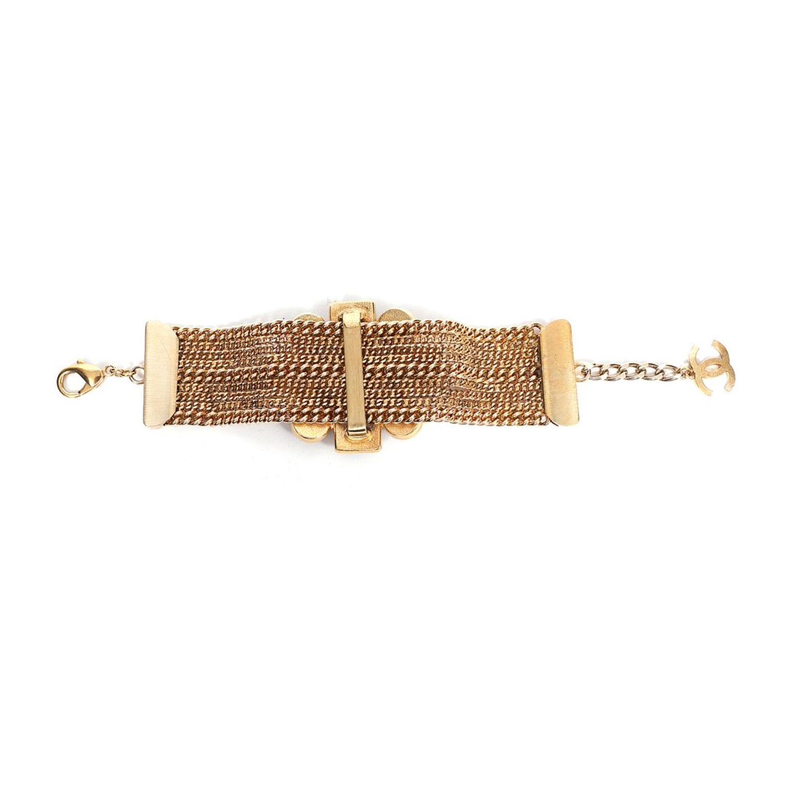 This bold multi-strand beaded cuff features a bold poured glass detailing with gold hardware and small crystal bead accents. Featuring a cloister clamp on one end and a Chanel CC logo on the other.

COLOR: Gold, black
MATERIAL: Metal, crystal
ITEM