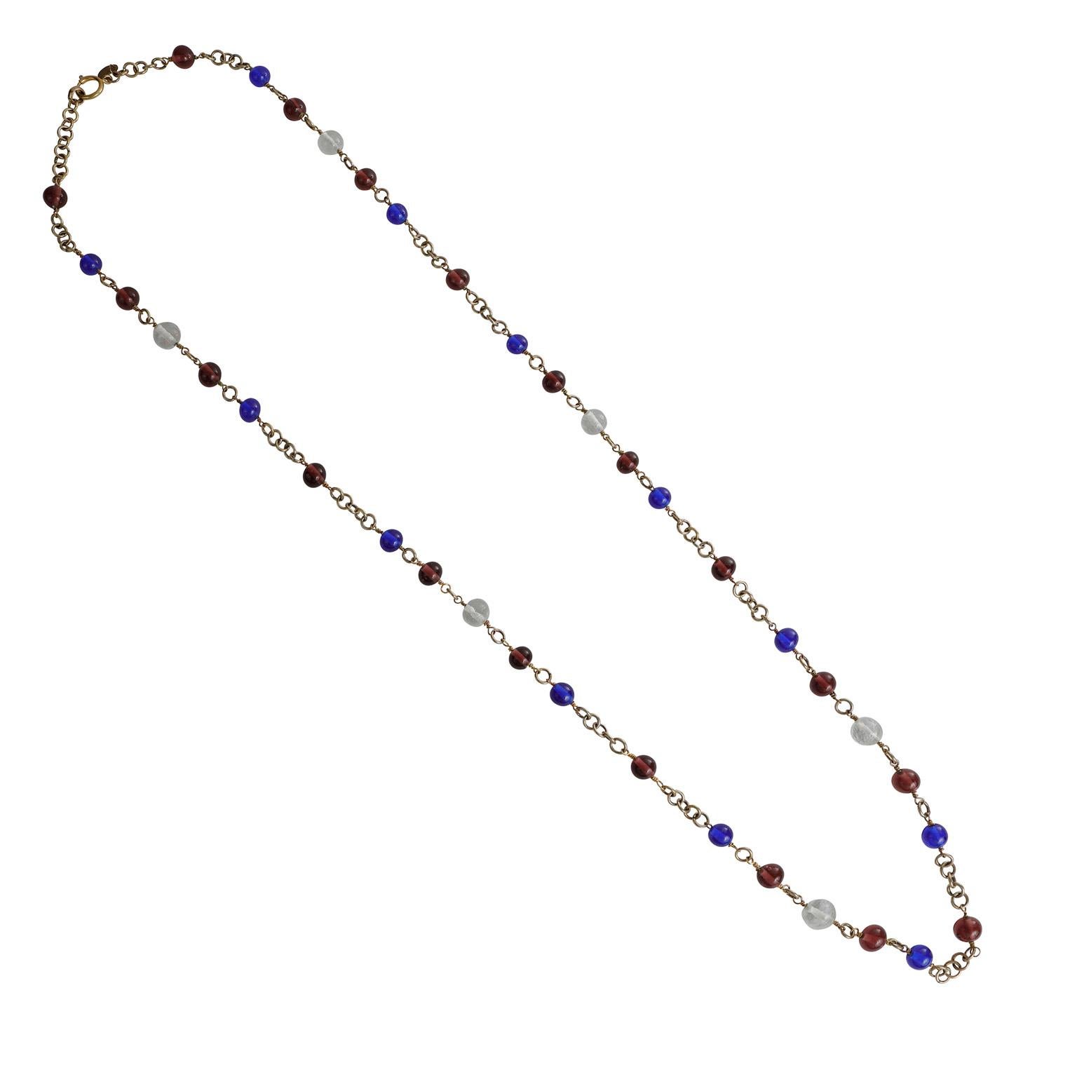 This authentic Chanel Purple and Blue Gripoix Beaded Necklace is in excellent vintage condition from the 1980’s.  Cobalt blue, purple and clear Gripoix glass beads are situated throughout a long gold tone chain with adjustable length.     Pouch or