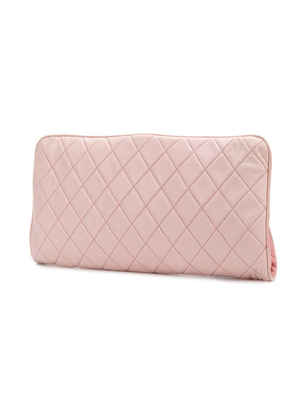 Pink lambskin quilted clutch bag from Chanel Vintage featuring a foldover top and a signature interlocking CC logo. 

Colour: Pink

Composition: Lambskin

Measurements: W: 35cm, H: 17cm, D: 4cm

Condition: 9/10