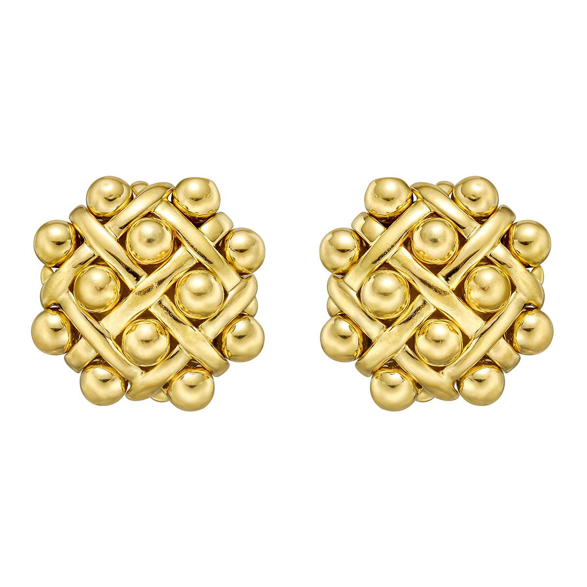 A magnificent pair of authentic Chanel earrings showcasing a quilted pattern in shimmering 18k yellow gold. The earrings have clip on backs and have the option for pierced ears as well.