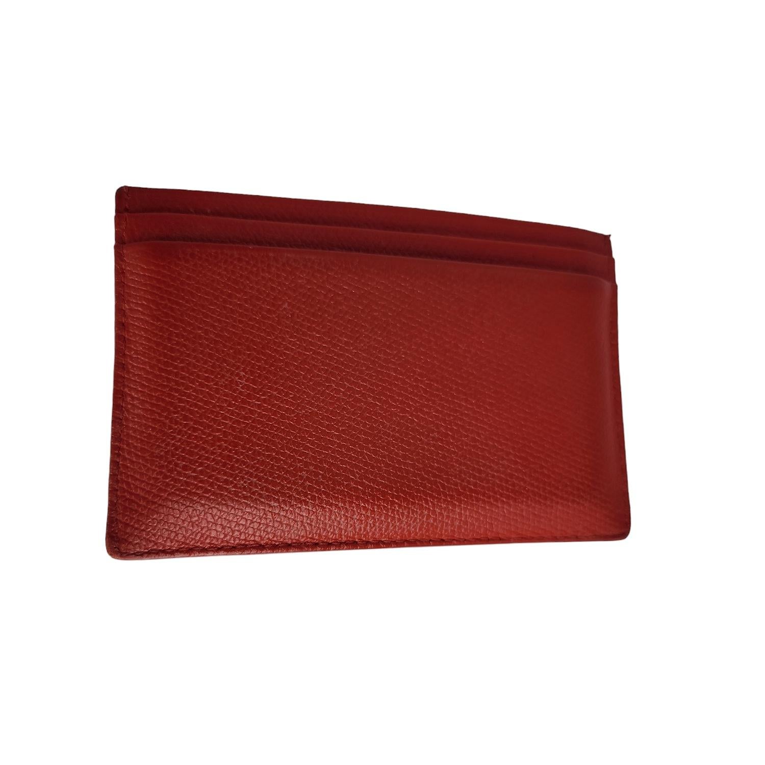 Vintage from the 2004-2005 Collection; this cardholder is crafted of red caviar leather. It features 1 card slot in front and 3 card slots in back, it's beautifully adorned with a small polished light gold CC logo on the front.

Designer: