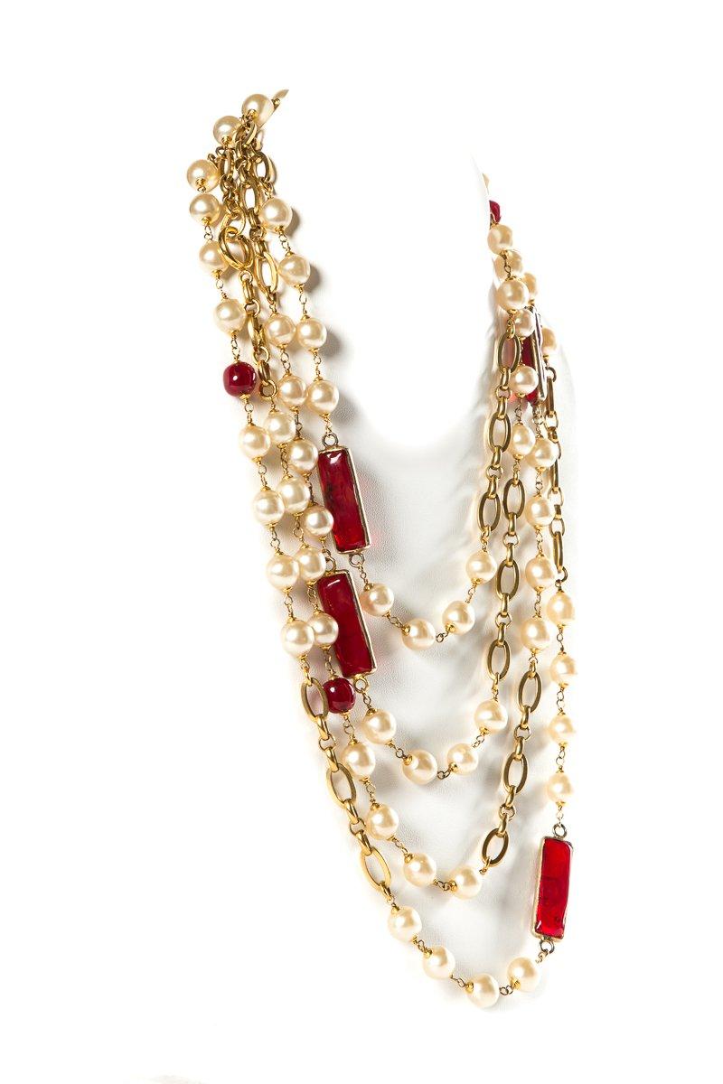 Chanel red Gripoix and faux pearl vintage 1980's necklace with gold-tone hardware and chain links.
 
This item has been previously worn and contains some signs of wear including micro-scratches on hardware. Good previously used condition consistent