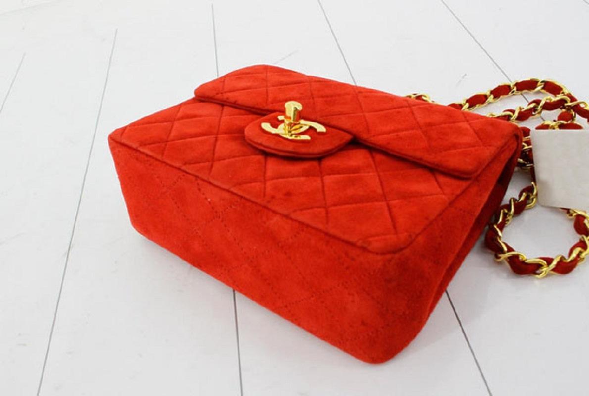 Chanel Vintage Square Mini Flap bag is made with diamond quilted suede in red with gold-tone hardware. The bag features a chain interlaced with leather shoulder strap, a main fold-over top, interlocking CC turn lock closure, back slip pocket and an