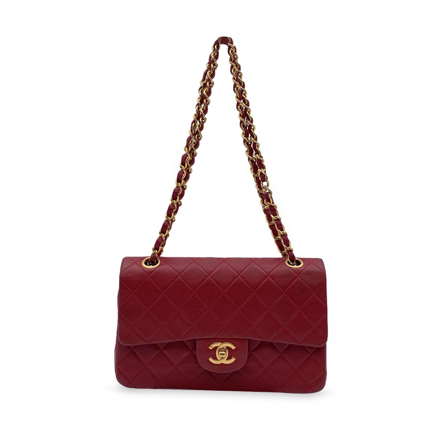 Chanel 'Timeless Classic 2.55' Quilted Double Flap 2.55 Bag in red color. Periord/Era: 1989-1991. Features double 'CC' turn lock closure and double flap interior. 1 open pocket under the flap. Gorgeous gold metal strap with interwoven leather; can