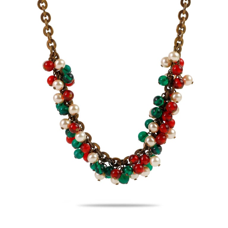 This authentic Chanel Vintage Red White and Green Gripoix Choker is in excellent condition.  Very early vintage Chanel; collectible.  Dark gold tone link chain is adorned with Gripoix spheres in red and green.  Interspersed with faux pearls.  Choker