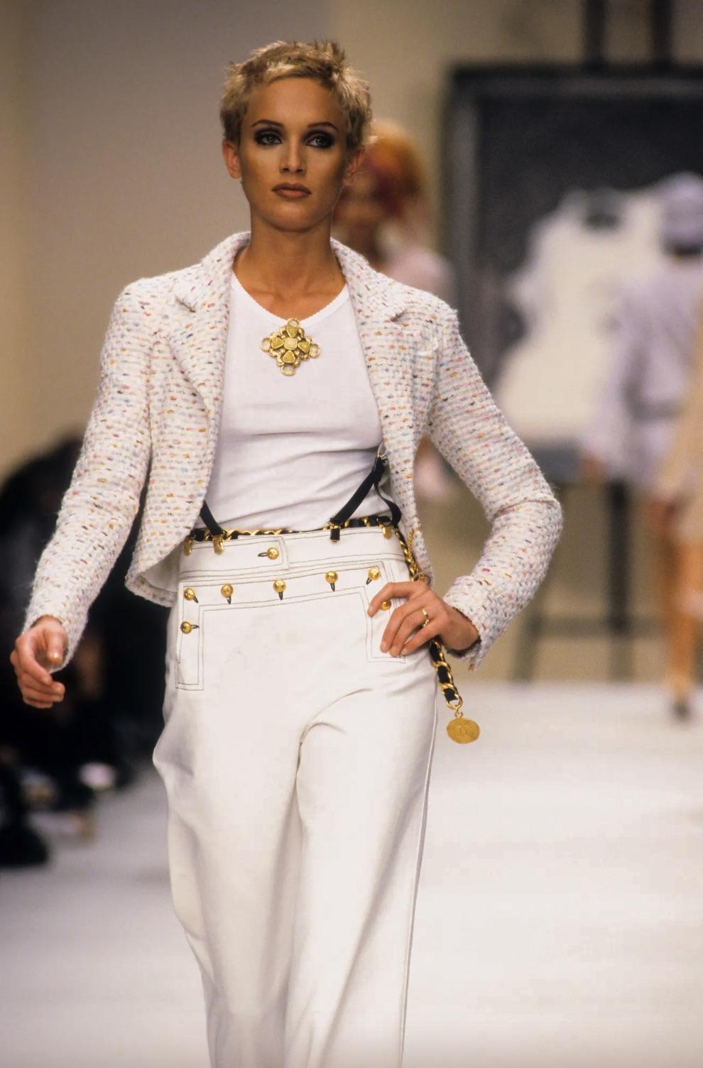 Presenting a cute and chic tweed jacket from Chanel's Spring/Summer 1994 collection and seen on supermodel Beri Smither. This jacket exudes a sense of playfulness with its fantasy tweed adorned in shades of pink, orange, blue, and purple. The