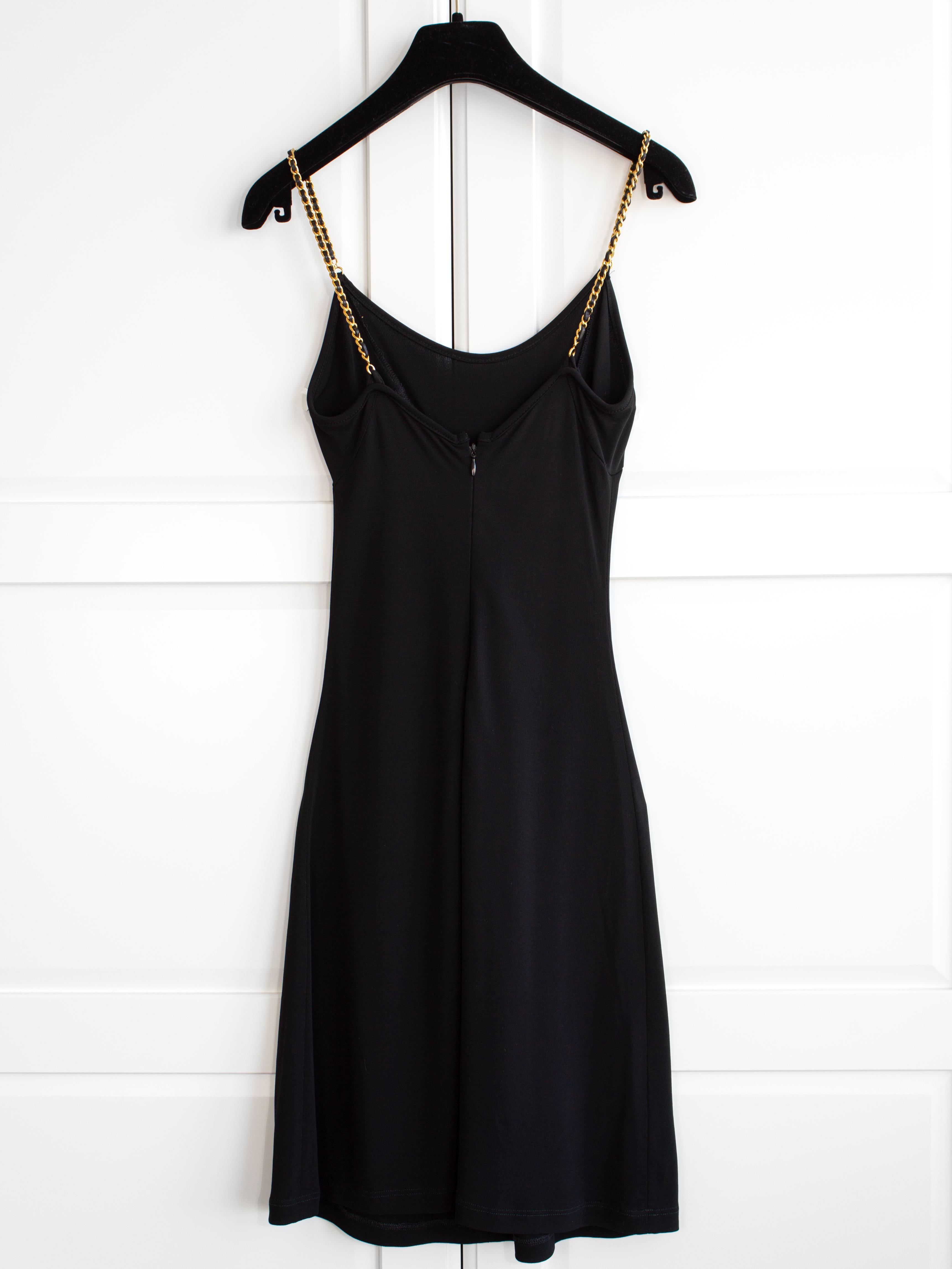 This little black dress is a cute and versatile piece from Chanel's Spring/Summer 1997 collection. It is made of black viscose and features delicate gold leather chain straps, adding just the right amount of edge. The skater style makes it suitable
