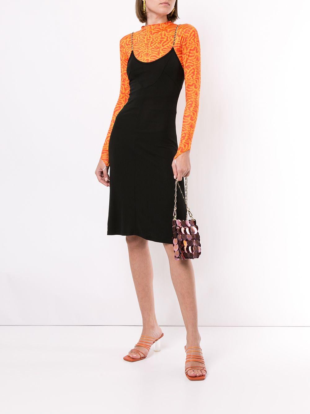 This little black dress is a cute and versatile piece from Chanel's Spring/Summer 1997 collection. It is made of black viscose and features delicate gold leather chain straps, adding just the right amount of edge. The skater style makes it suitable