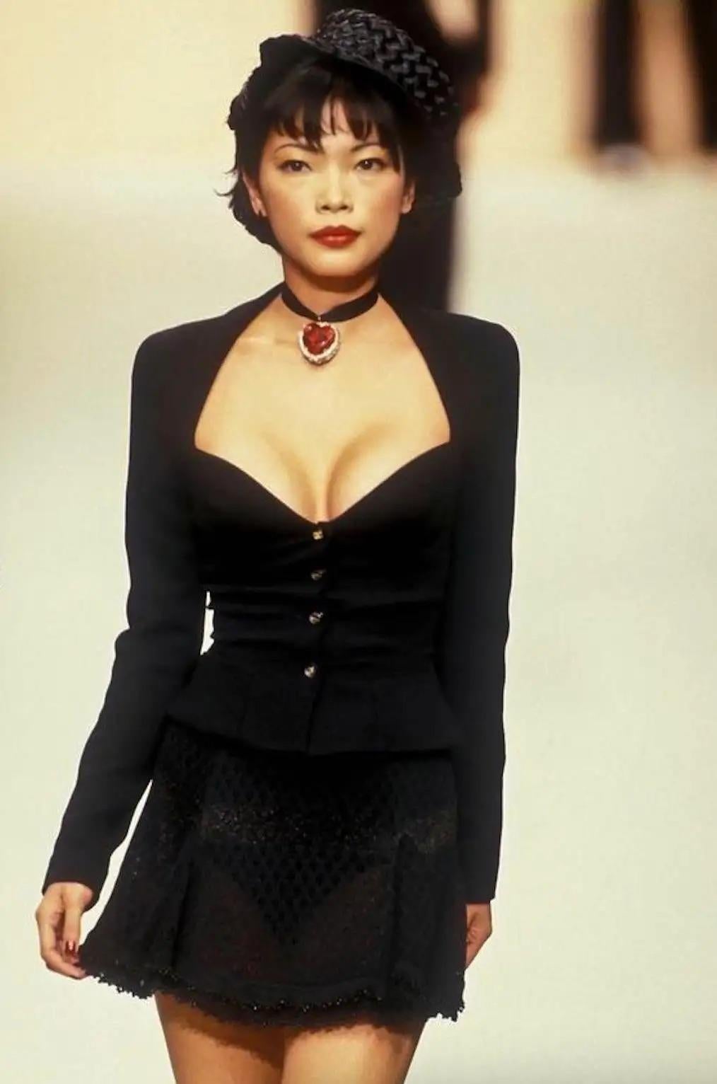 The Chanel Spring/Summer 1995 'Barbie' collection is a real gem for any vintage lover, and this  belted jacket seen on supermodels Claudia Schiffer, Cindy Crawford, and Navia Nguyen perfectly fits the bill. The cropped length of the jacket features