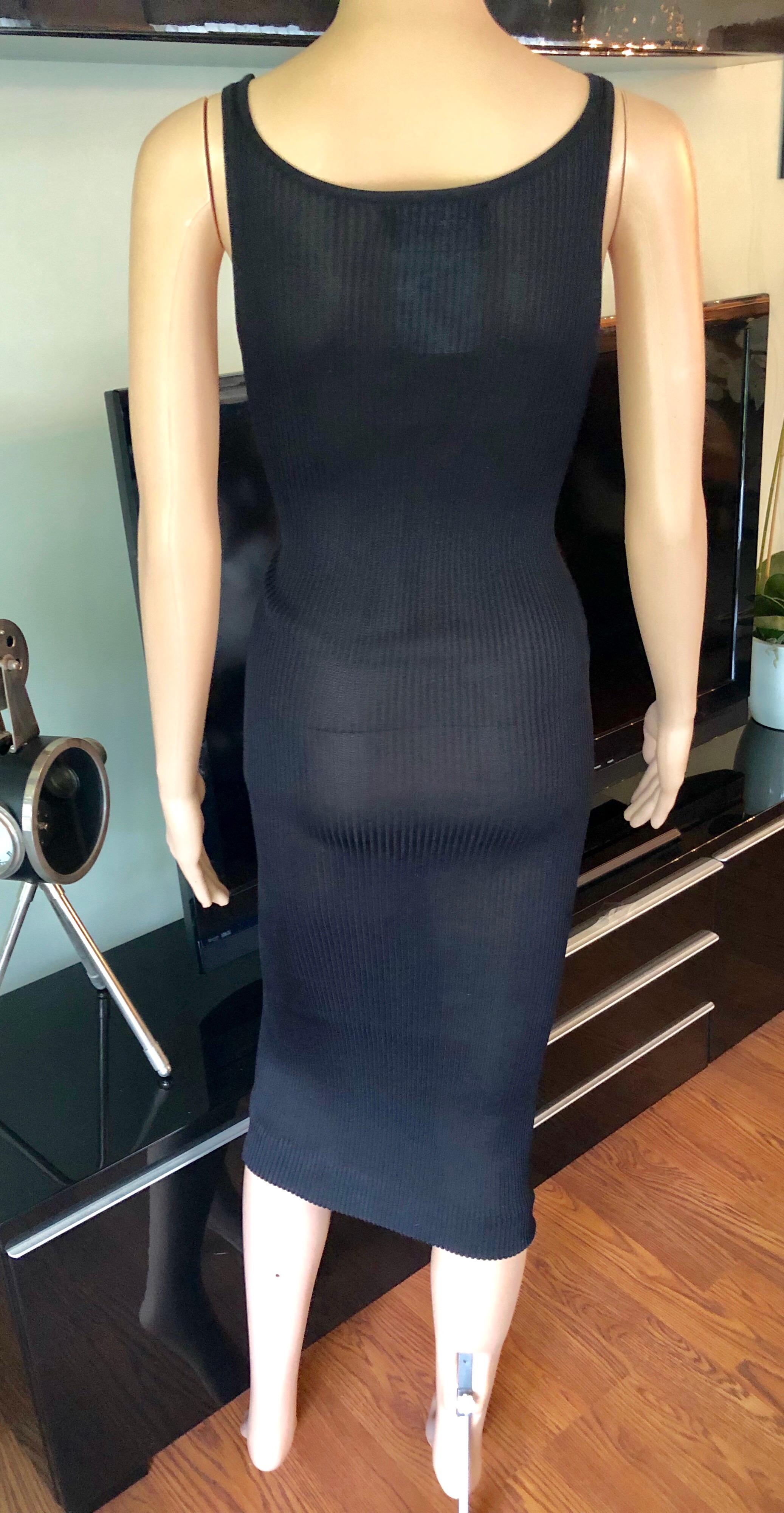 Chanel Vintage Sheer Silk Knitted Bodycon Black Dress FR 34

Chanel Boutique Vintage sheer silk rib knit dress featuring scoop neck and single interlocking CC embroidery at left shoulder.
