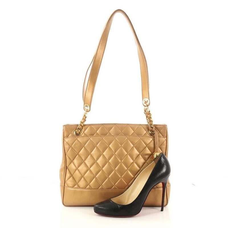 This authentic Chanel Vintage Shopping Tote Quilted Leather Medium is a classic in Chanel's timeless collection. Crafted in copper metallic quilted leather, this chic and iconic tote features woven-in leather chain with flat leather straps, front