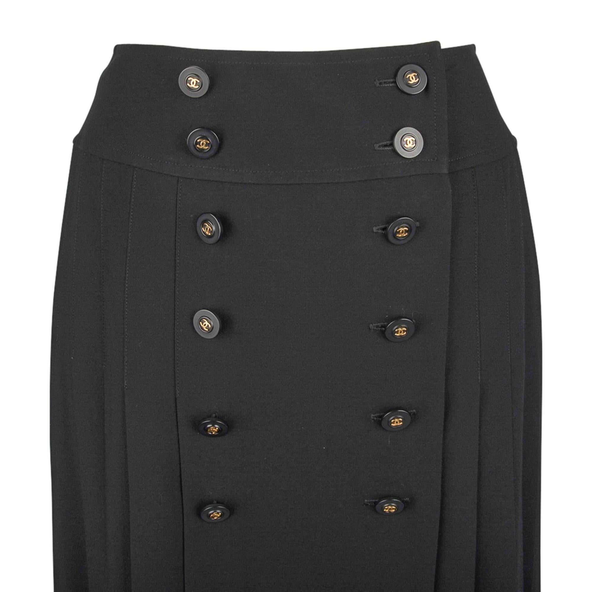 Guranteed authentic Chanel pleated black wool skirt.
Center placquet has 2 rows of 6 buttons each.
All buttons are black with gold center CC. 
3