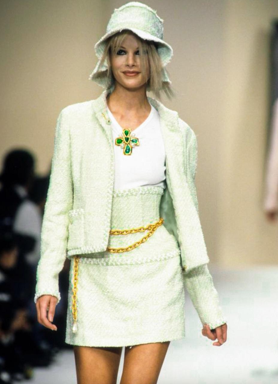 This collectible Chanel vintage suit from the Spring 1994 collection is an absolute must-have for every fashion connoisseur. Featuring an open-front jacket and pencil skirt made of green, yellow and white fantasy tweed, adorned with signature CC