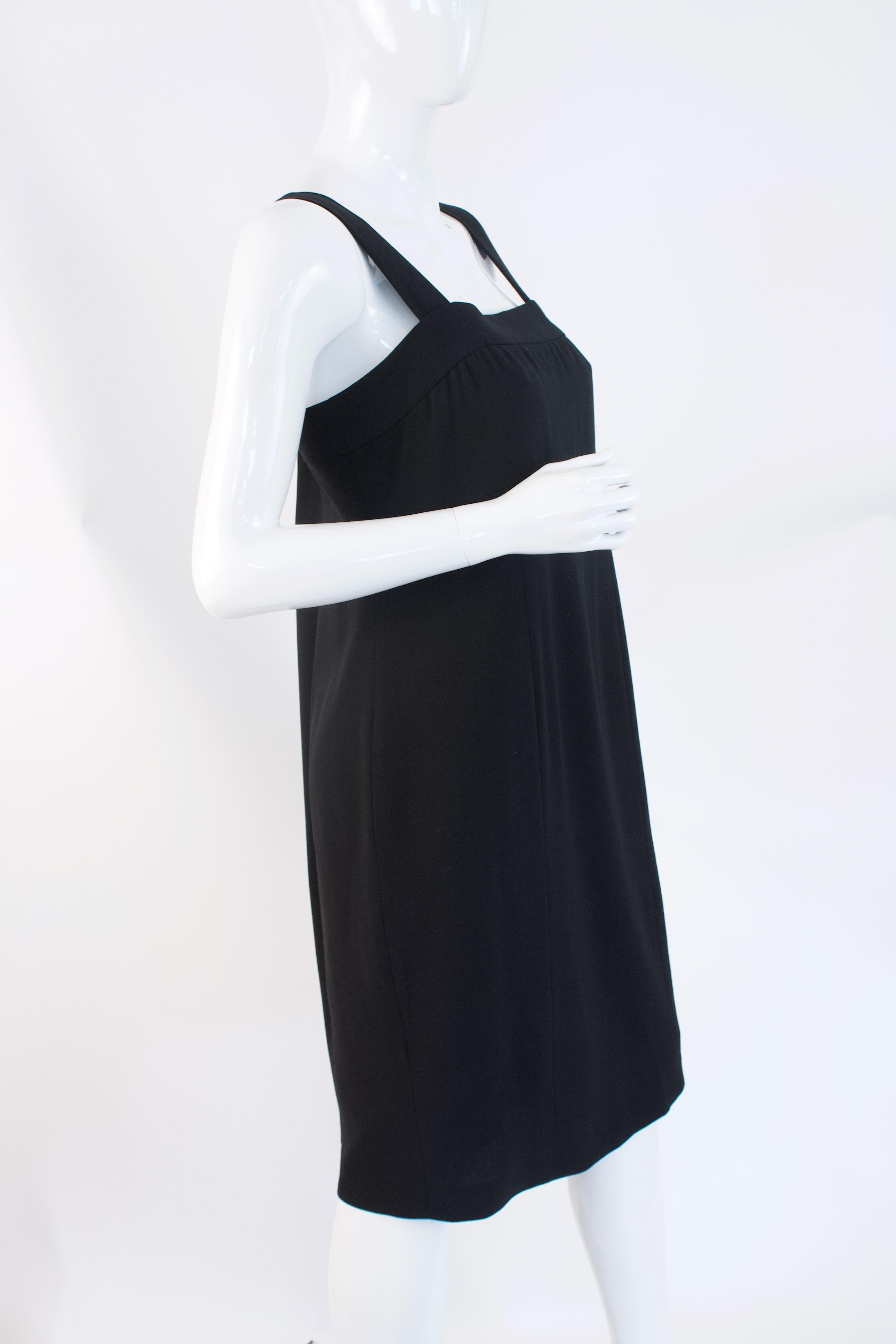 Vintage CHANEL Spring 1998 Little Black Dress.  This classic piece is made from light weight wool and lined in silk.  Two logo buttons adorn the back. 
 
Designer: Chanel


Condition: Excellent, light wear

Size:  44, fits like a medium

Length: 34