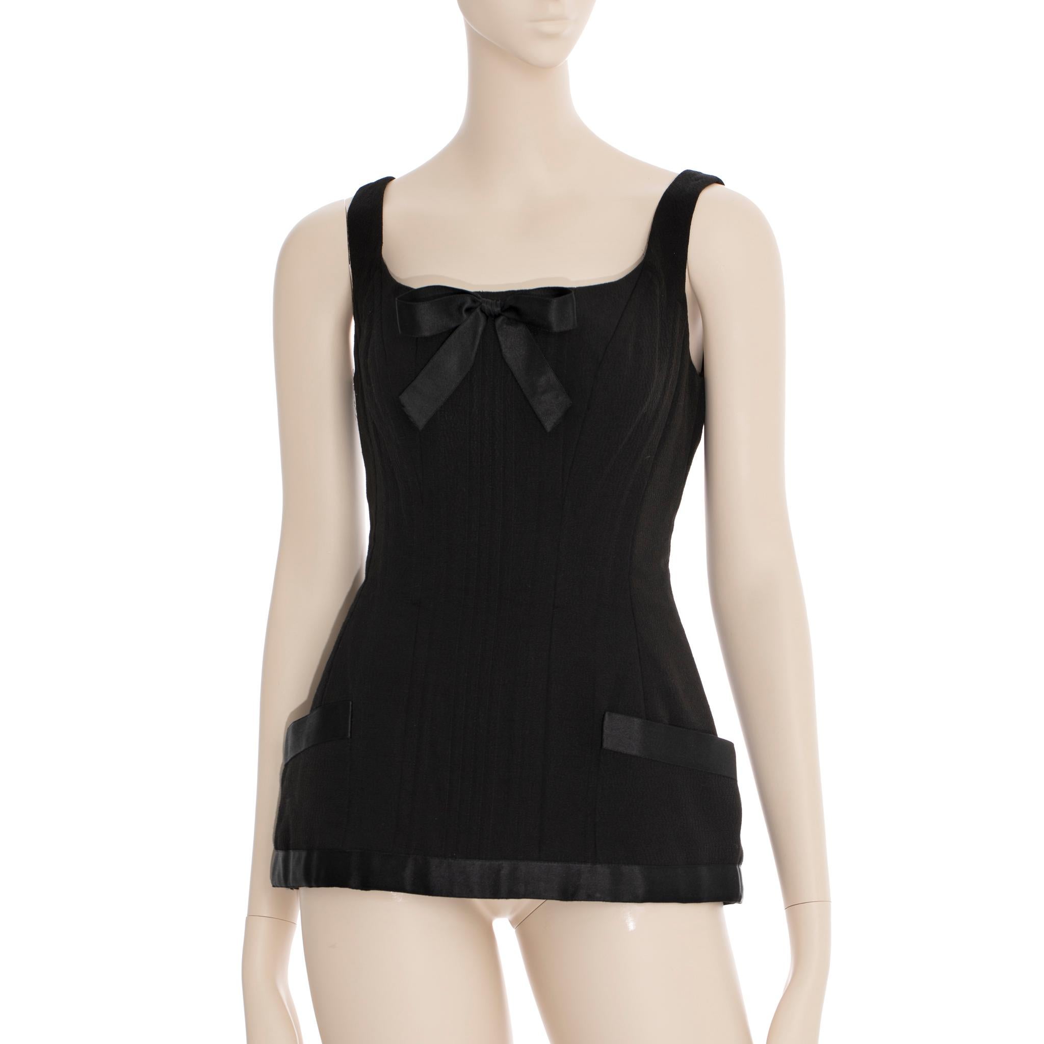 Rare black corset top from the Spring/Summer 1993 collection of Chanel. Supermodel Tatjana Patitz was infamous for donning one of Karl Lagerfeld's classic creations. This hourglass-shaped corset top is an heirloom-quality design that endures the