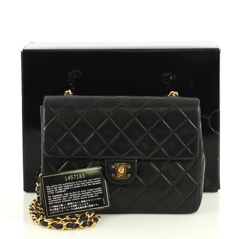 This Chanel Vintage Square Classic Flap Bag Quilted Lambskin Small, crafted from black quilted lambskin leather, features woven-in leather chain link strap and gold-tone hardware. Its CC turn-lock closure opens to a red leather interior with zip and