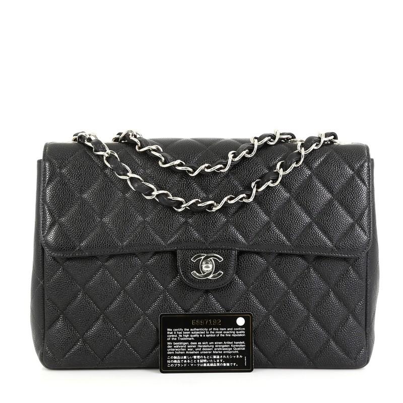 This Chanel Vintage Square Classic Single Flap Bag Quilted Caviar Jumbo, crafted from black quilted caviar leather, features woven-in leather chain strap, exterior back slip pocket, and silver-tone hardware. Its CC turn-lock closure opens to a black