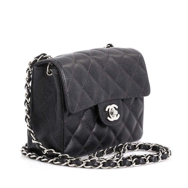 This Chanel Vintage Square Classic Single Flap Bag Quilted Caviar Mini, crafted from black quilted caviar leather, features woven-in leather chain strap, exterior back slip pocket, and silver-tone hardware. Its CC turn-lock closure opens to a black