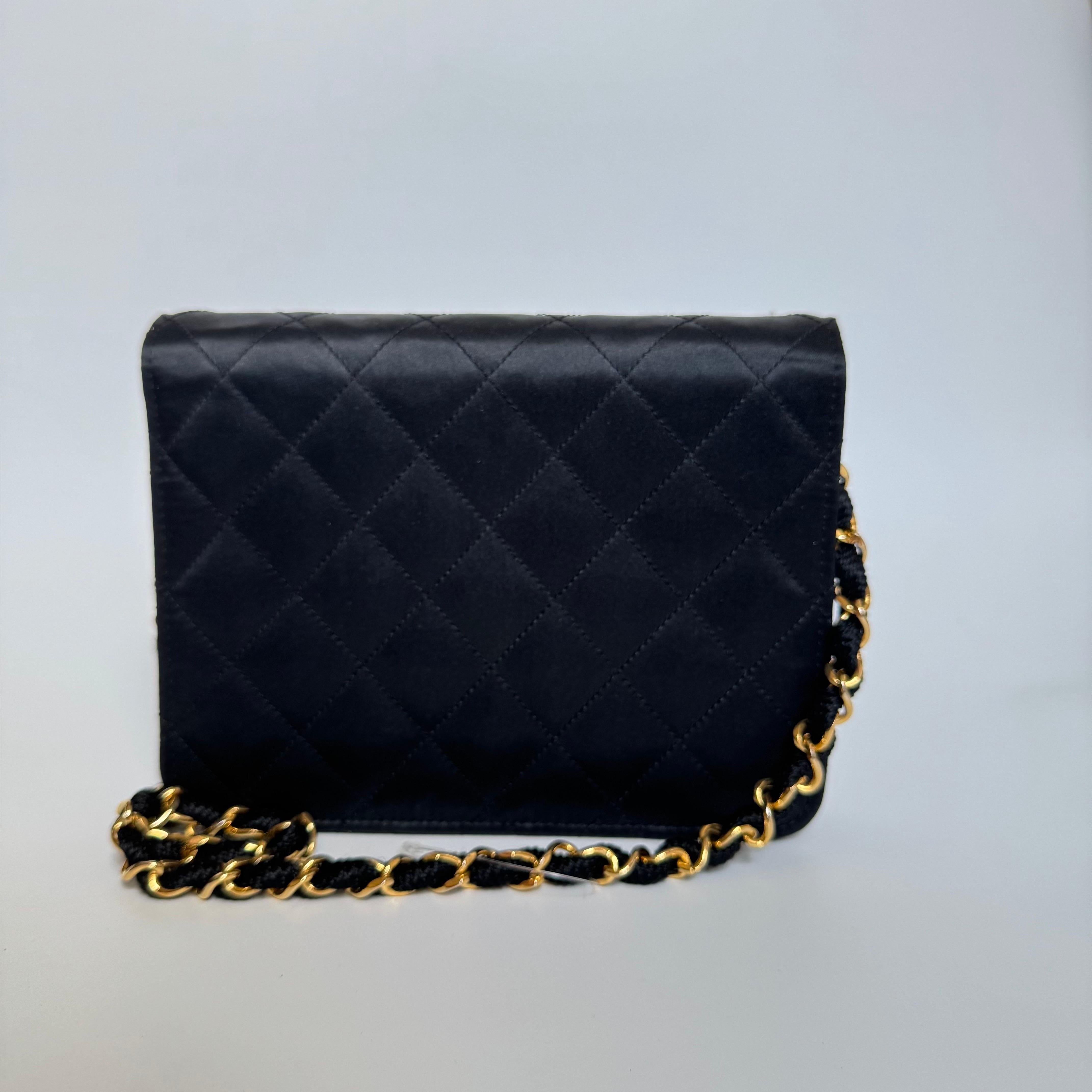 This one-of-a-kind Chanel Classic Flap Vintage bag in black silk with 24k Gold hardware is sure to grab attention in a crowd! 

CONDITION: VERY GOOD ORIGINAL CONDITION

This preloved authentic Chanel bag is in very good condition. There are some