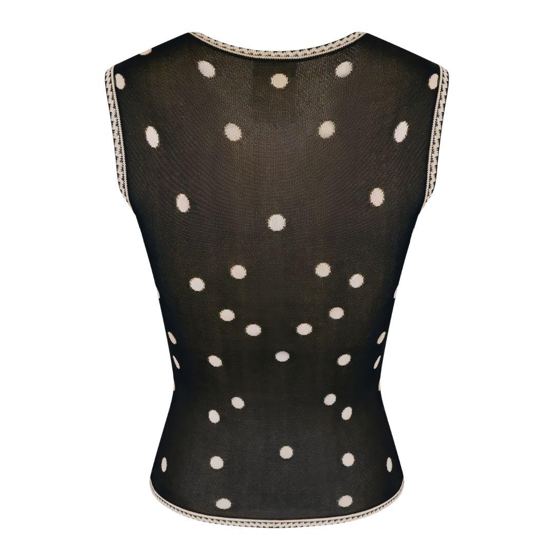Vintage Chanel sleeveless knit sweater top with floral and polka dot pattern in black and beige from Spring/Summer 2002 collection.

Form fitting with a zig zag trim along the neckline, arms and hem. V-neckline. Features a metal logo button sewn at