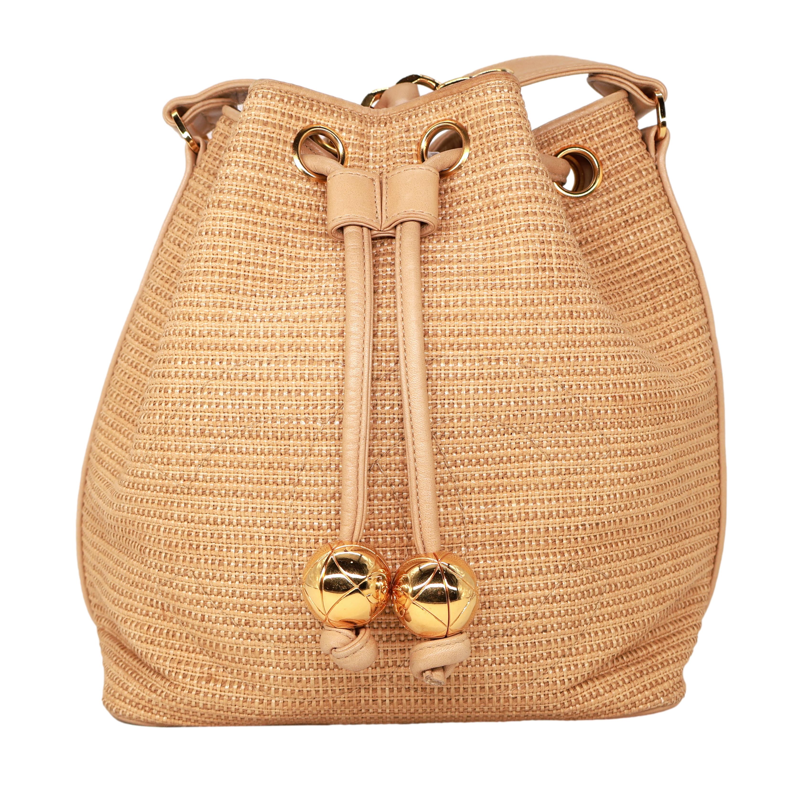 Chanel Vintage Tan Woven Raffia and Leather Drawstring Bucket Bag, 1992-1993. This highly coveted and rare collectible raffia bucket bag was produced between 1992 - 1993, baring a serial code of 