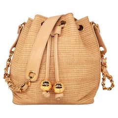 Borsa a secchiello Chanel vintage in rafia intrecciata e pelle, 1992-1993.
