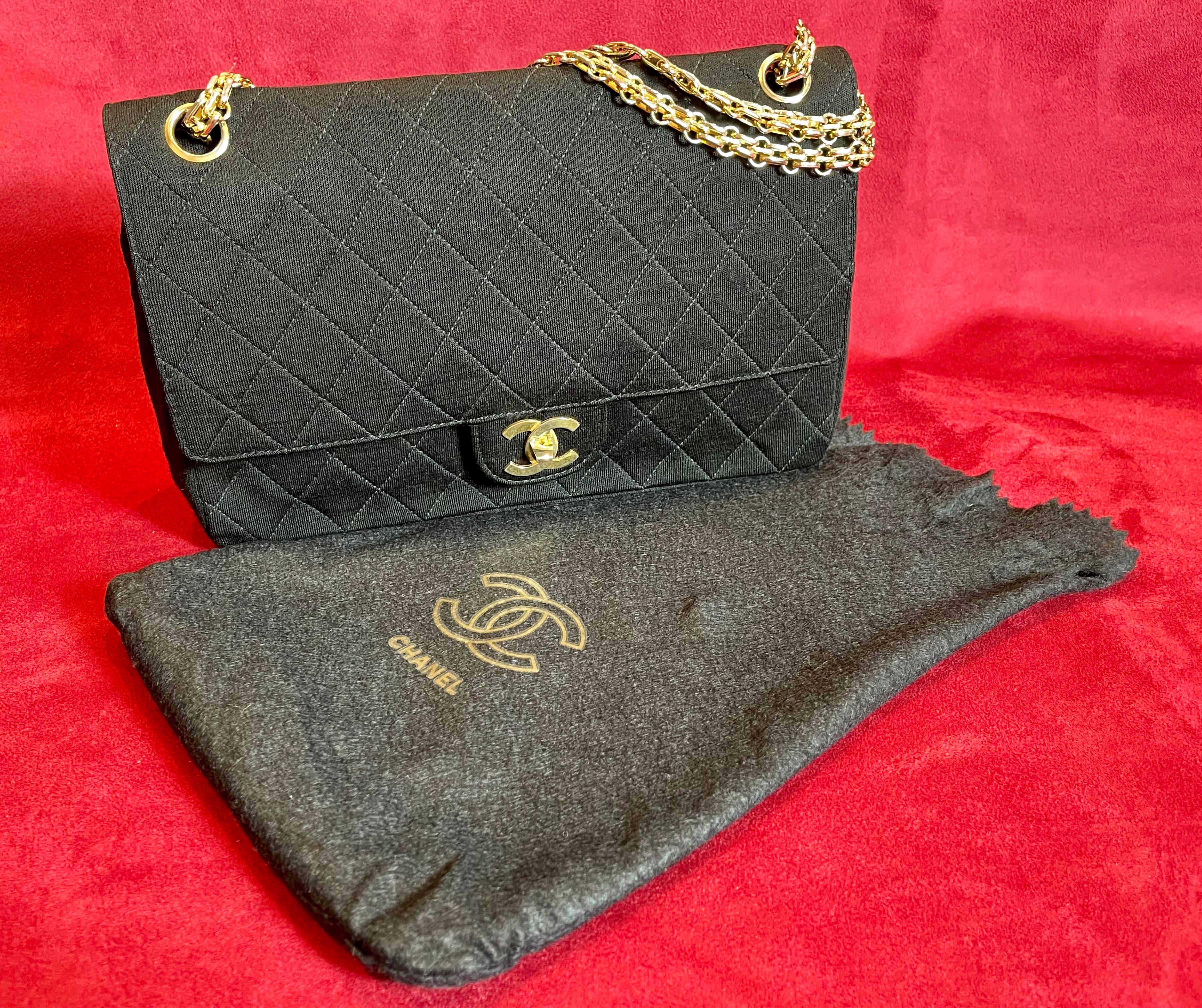 Lovely Chanel timeless handbag in black quilted jersey bought in the early 80s in the Chanel Boutique located 19 Rue Cambon - 75001 Paris.
Hardware in gilt metal, chain strap in gilt metal allowing the bag to be worn in the hand or on the shoulder.