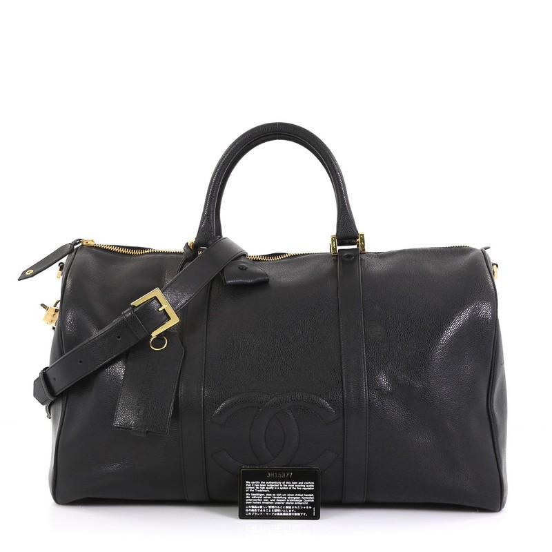 This Chanel Vintage Timeless Boston Bag Caviar Large, crafted in black caviar leather, features dual rolled leather handles and gold-tone hardware. Its zip closure opens to a black fabric interior with zip pocket. Hologram sticker reads: 3815377.