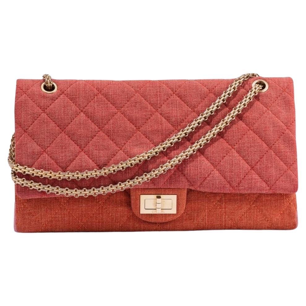 Chanel Vintage Timeless Orange Pink Quilted Denim Shoulder Bag

Orange, red and pink 2009 Timeless quilted-canvas shoulder bag featuring a gold-tone chain shoulder strap, internal slip pockets, fold-over top with twist-lock closure and a back