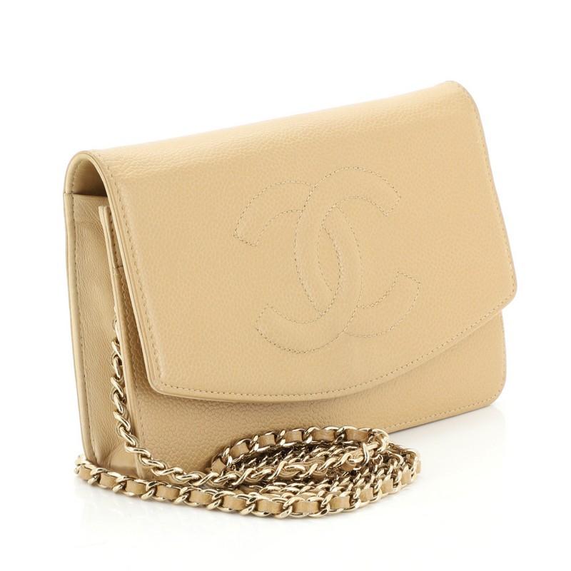 This Chanel Vintage Timeless Wallet on Chain Caviar, crafted in neutral caviar leather, features woven-in leather chain strap, interlocking CC logo stitched on the front, exterior back zip pocket, and gold-tone hardware. Its hidden snap button