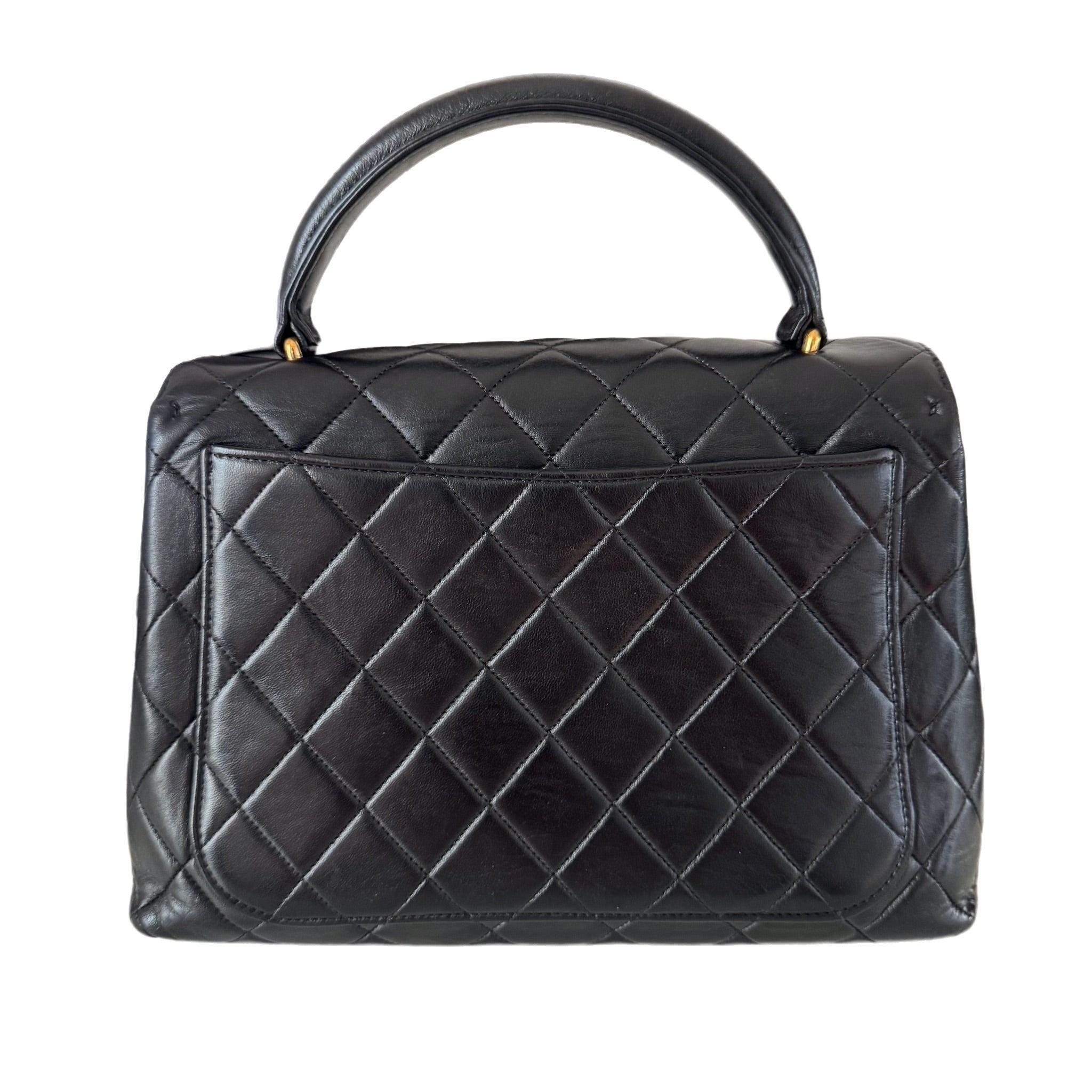 Chanel Vintage Top Handle Kelly Coco Handle Black Flap Bag lambskin leather 24k Gold Hardware
 These are professional photos of the actual bag.
 Unleash your inner icon with this exquisite Vintage Chanel Top Handle Kelly Flap Bag, the predecessor of