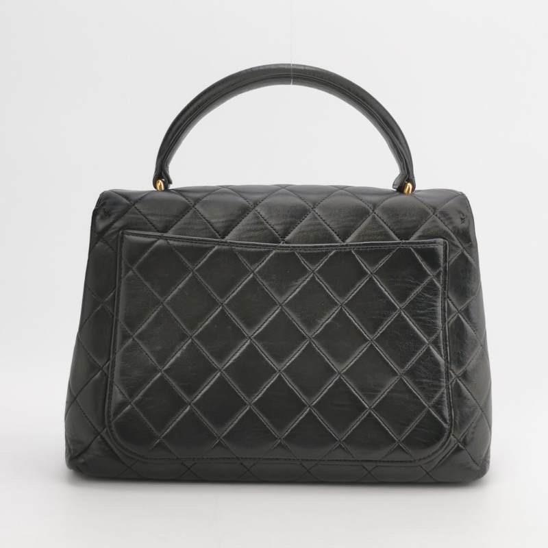 Chanel Vintage Top Handle Kelly Coco Handle Black Flap Bag lambskin leather 24k Gold Hardware
 These are professional photos of the actual bag.
 Unleash your inner icon with this exquisite Vintage Chanel Top Handle Kelly Flap Bag, the predecessor of