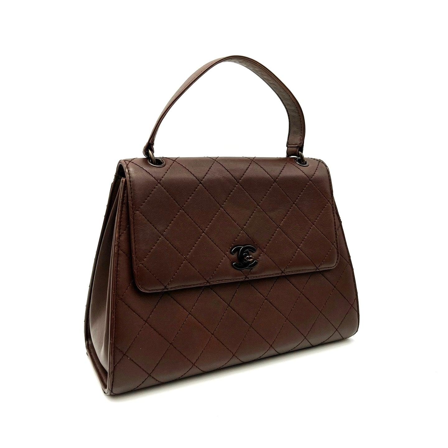 Chanel Vintage Top Handle Kelly Flap Bag Chocolate Brown Cannage Lambskin Leather, 1997-1999
  These are professional photos of the actual bag.
  CONDITION: VERY GOOD
  Original condition. Rubbing around the corners but overall condition is still