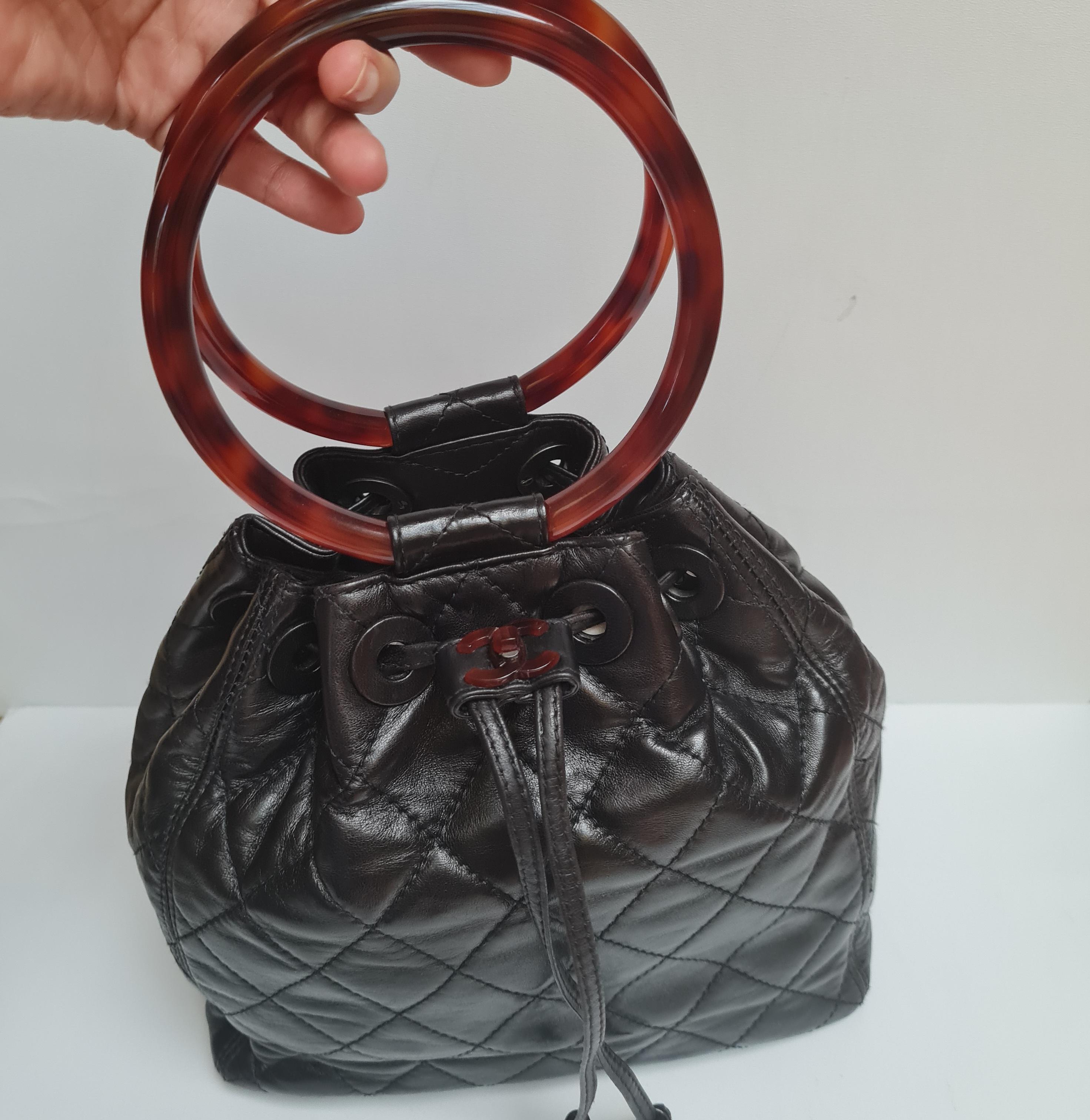 Rare Tortoise Shell Handle Bucket Bag. Soft lambskin quilted bag that's perfect for your everyday bag. Light wrinkling on the leather surface and rubbing on the corners. 

Inclusion: Dust Bag

Serial Number: #4673997 (1996-1997)

Closure: Drawstring