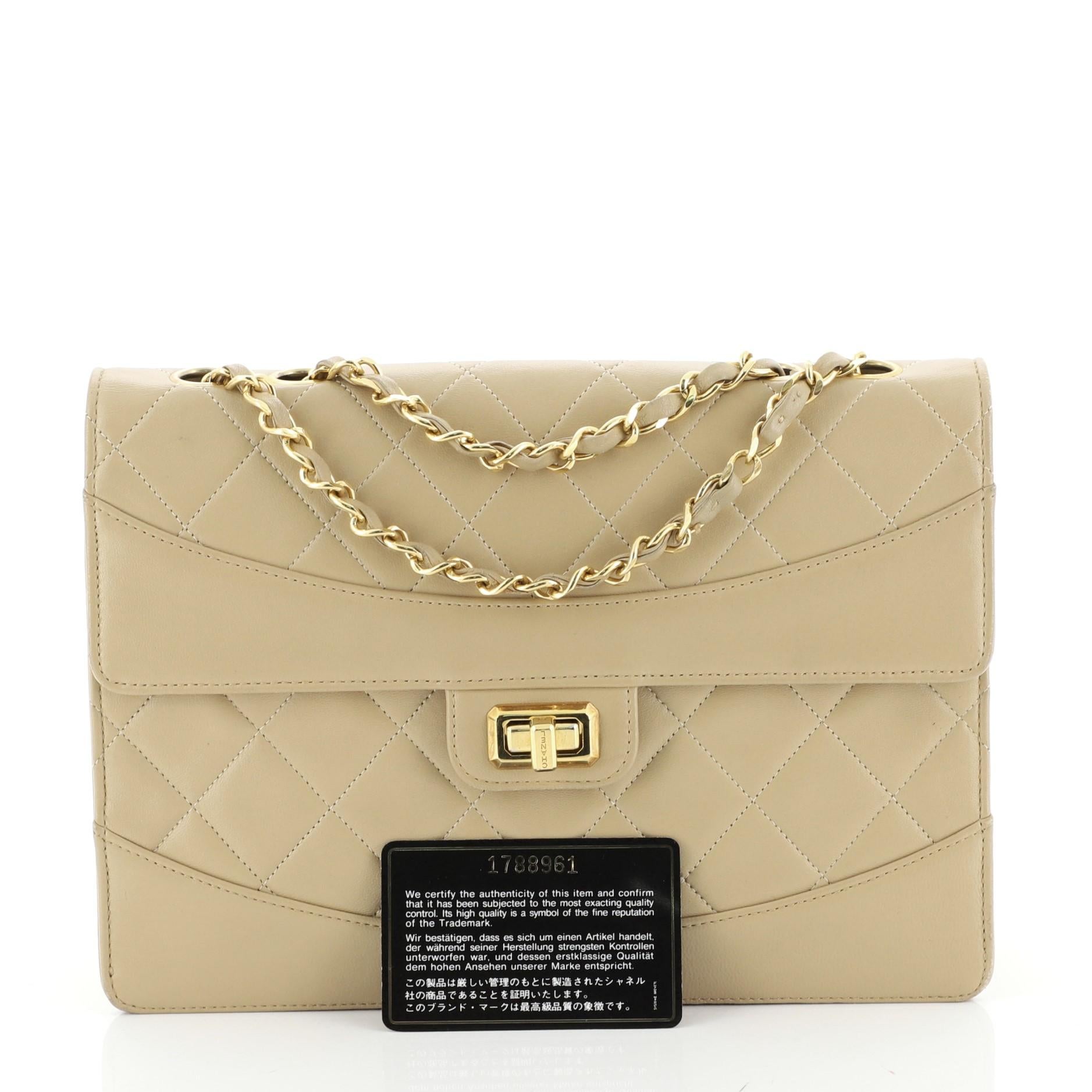 This Chanel Vintage Trapezoid Flap Lock Bag Leather Medium, crafted in neutral leather, features woven-in leather chain strap, protective base studs, and gold-tone hardware. Its turn-lock closure opens to a neutral leather interior with side zip and