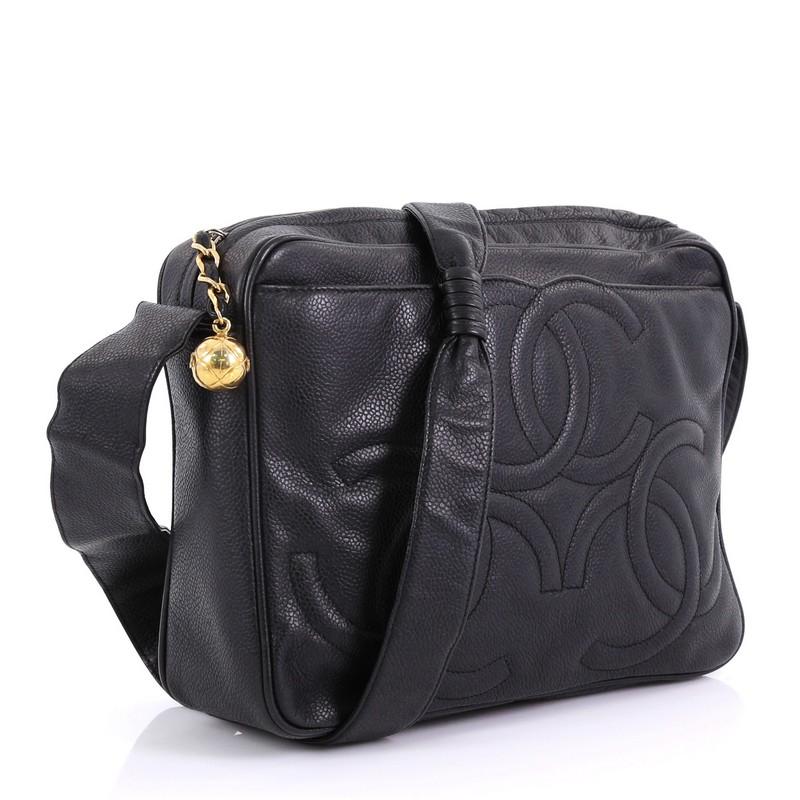 This Chanel Vintage Triple CC Camera Shoulder Bag Caviar Medium, crafted from black caviar leather, features flat leather strap, exterior front slip pocket with triple stitched CC logo, and gold-tone hardware. Its zip closure opens to a black