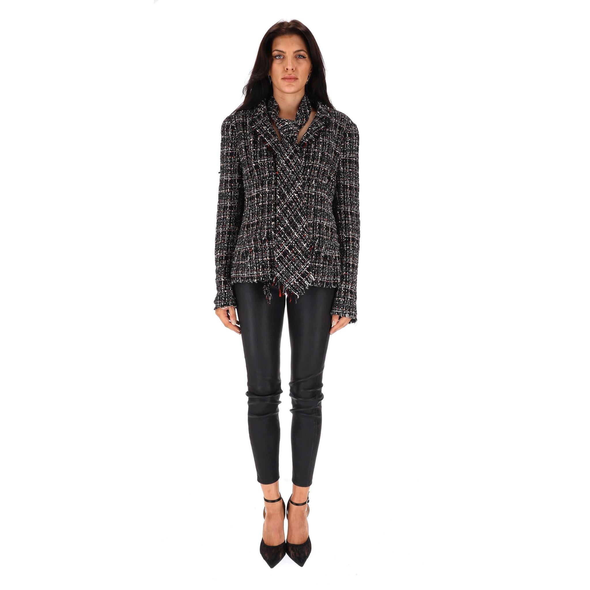 Chanel Vintage Tweed Jacket With Matching Tie

Black tweed blazer crafted with white and red yarns, designed with detachable matching tie.

'CC' logo buttoned front and cuffs, tailored fit, lapelled collar and silk lining.

Chanel's signature chain
