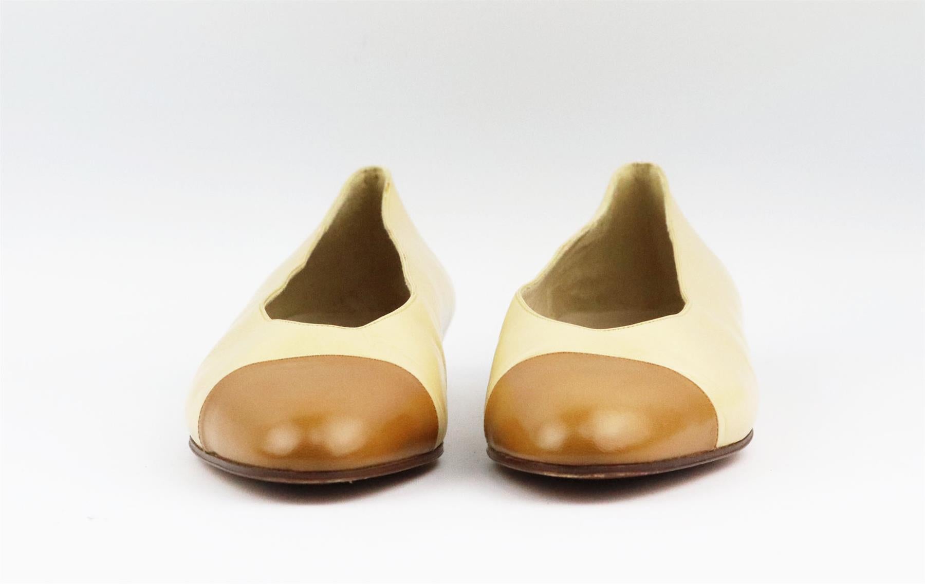 These vintage ballerina flats by Chanel are always stand out pieces, even designs as classic as these flats, made in Italy from beige leather and tan leather toe cap that are balanced out with an almond toe. Sole measures approximately 10 mm/ 0.4