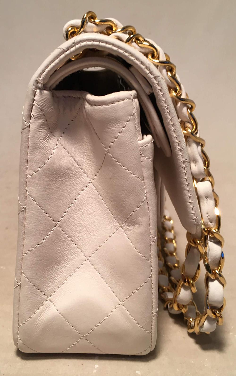 Chanel Vintage White 9 inch 2.55 Double Flap Classic Shoulder Bag in excellent condition. White quilted lambskin exterior trimmed with gold hardware and signature woven chain and leather shoulder strap that can be worn short or long to suit your